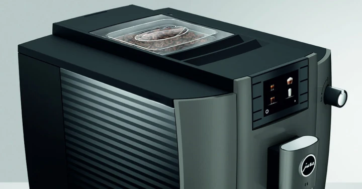 Ekspres Jura E6 EC w kolorze Dark Inox, zbliżenie na panel sterujący z kolorowym wyświetlaczem oraz pokrywę młynka