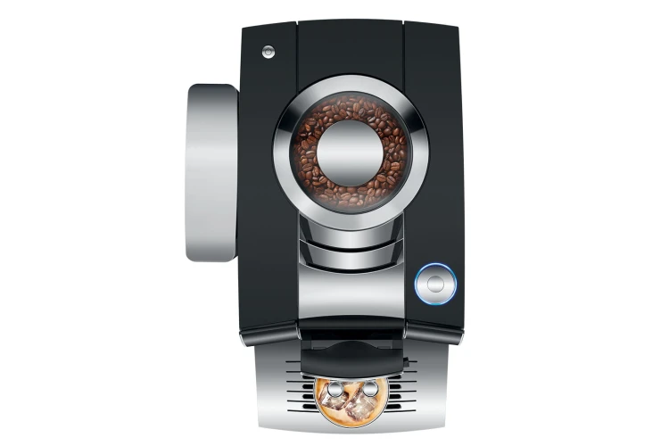 Ekspres Jura Z10 w kolorze błyszczącej czerni, zaprezentowany od góry, z widokiem na zbiornik ziaren oraz rotary switch, ze szklanką kawy Cold-brew